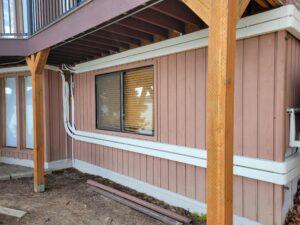 Neatly installed HVAC line set covers running along the exterior of a residential building, ensuring a clean and organized appearance for the dual LG units.