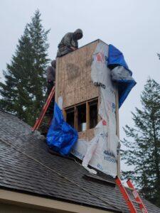 Technicians repairing a chimney structure in rainy weather, ensuring proper ventilation and functionality for the home's heating system.