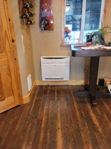 LG floor-mounted mini-split HVAC unit installed in a cozy living space, providing efficient heating and cooling for year-round comfort.