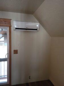 LG wall-mounted mini-split HVAC unit installed in a residential room, providing efficient heating and cooling for a comfortable indoor environment.