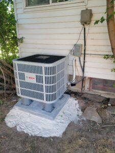 Bosch outdoor HVAC unit installed next to a residential home, providing efficient cooling and heating for year-round comfort.